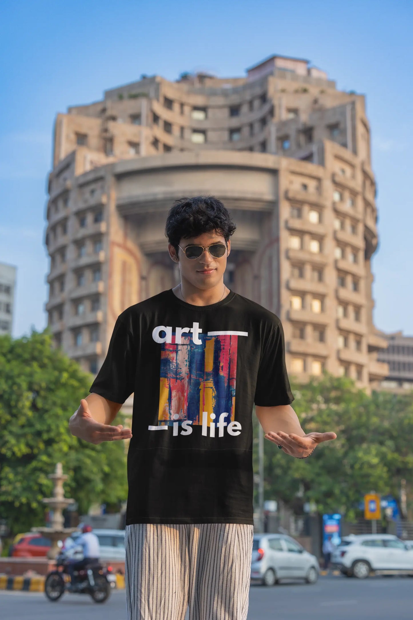 Man-wearing-oversized-t-shirt-featuring-graphic-design-and-text-'Art-Is-Life'-perfect-for-casual-fashion-and-creative-expression.1