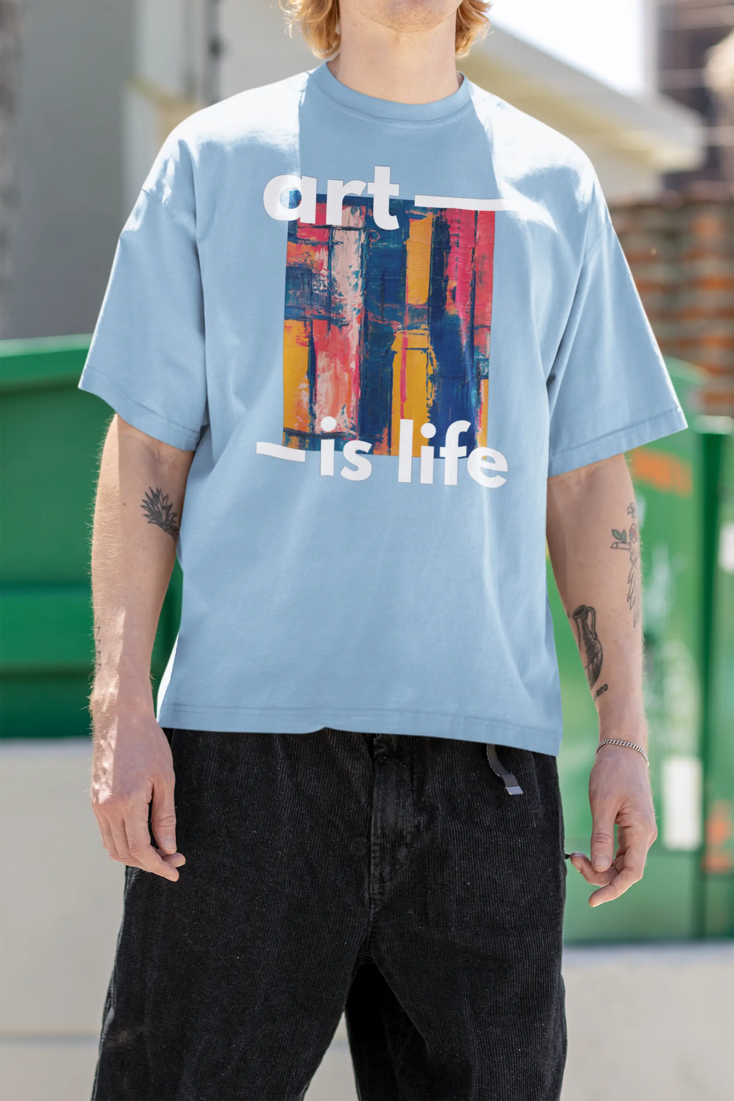 Man-wearing-oversized-t-shirt-featuring-graphic-design-and-text-'Art-Is-Life'-perfect-for-casual-fashion-and-creative-expression.2